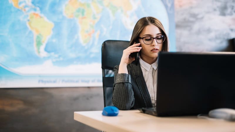 کارمند در حال بررسی مدارک و موقعیت‌های مهاجرت شغلی در دفتر کاریابی